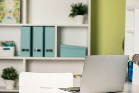 Office desk with laptop on table. Workspace with nobody. Copy space with blurry background.の写真素材