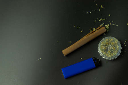 Smoking marijuana accessories and tools. Legal cannabis use. Black background with copy space. Weed...