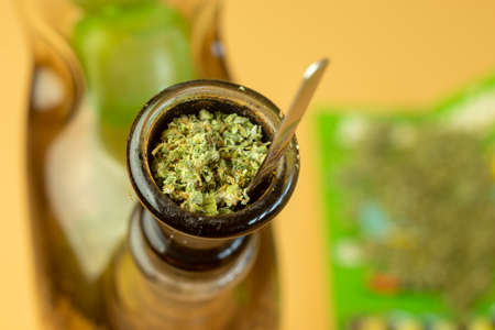 Bong filled with cannabis for recreational use. Marijuana legalize concept.