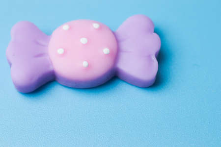 Sweet candy toy on blue background top view.