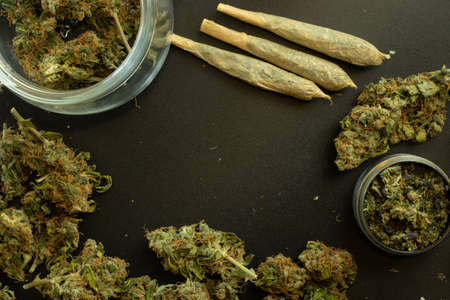 Marijuana concept design background template with copy space, weed buds top view. Cannabis joints.の写真素材