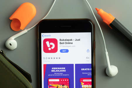 New York, USA - 26 October 2020: Bukalapak Jual Beli Online mobile app icon logo on phone screen close-up, Illustrative Editorial.のeditorial素材