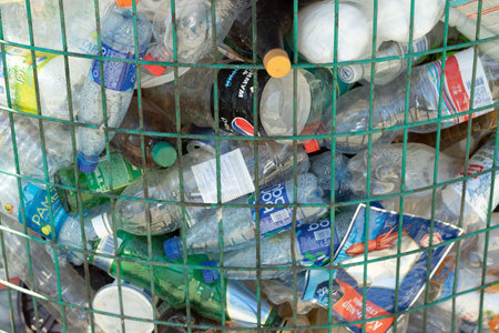 Moscow, Russia - 10 September 2020: Various rubbish in the trash can, product brand logos....