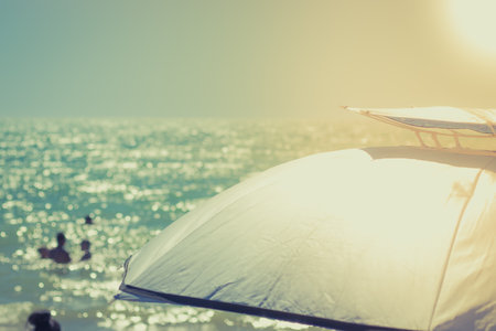 Summer vacation concept copy space. Very sunny weather, an umbrella for protection from the sun rays.の写真素材