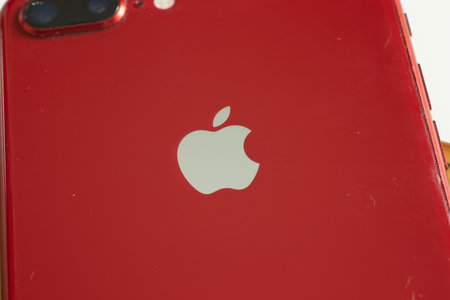 Moscow, Russia - 5 December 2020: Apple logo on red iPhone close-up, Illustrative Editorial.のeditorial素材