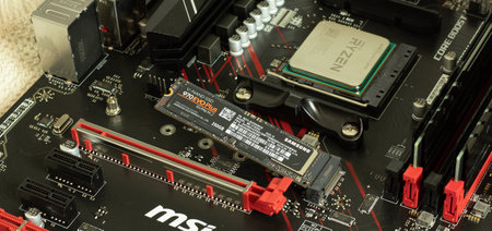 Moscow, Russia - 5 December 2020: Ryzen CPU in socket of MSI motherboard with Samsung SSD memory...