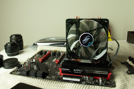 Moscow, Russia - 5 December 2020: PC MSI motherboard with CPU fan and RAM memory bars. Assembling...