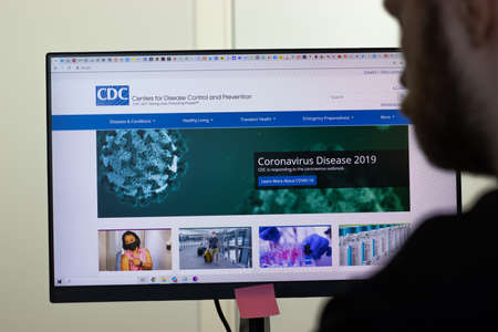 New York, USA - 26 April 2021: CDC website page on screen, man using service, Illustrative Editorial