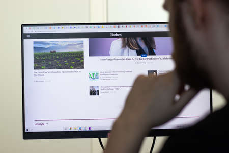 New York, USA - 26 April 2021: Forbes website page on screen, man using service, Illustrative Editorialのeditorial素材