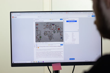 New York, USA - 26 April 2021: Reddit website page on screen, man using service, Illustrative Editorialのeditorial素材