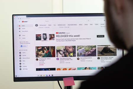 New York, USA - 26 April 2021: YouTube website page on screen, man using service, Illustrative Editorialのeditorial素材