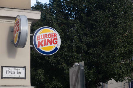 Budapest, Hungary - 1 November 2021: Burger King restaurant fast food logo on street, Illustrative Editorial.のeditorial素材