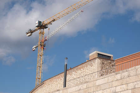 Budapest, Hungary - 1 November 2021: Construction crane repairing a historic building or landmark, Illustrative Editorial.のeditorial素材