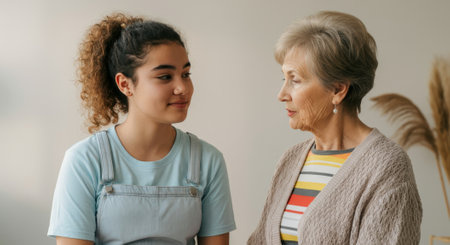 Young woman is sitting next to an older woman. The older woman is wearing a striped sweaterの素材