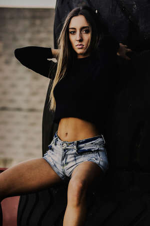 Nice girl posing in an industrial area for  fashion photography