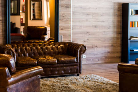 Great room of a hotel with a brown leather sofa in Madridの写真素材