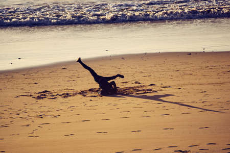 Orange sunset on a nice blue beach in the coast of Moroccoの写真素材