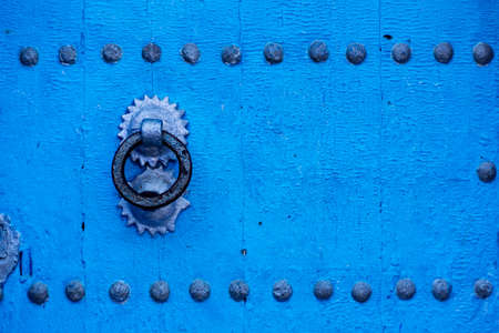 Old wooden blue door in the famous blue village of ChefChaouen in Moroccoの写真素材