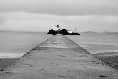 Long exposure view of the breakwater walk in the bikinis beach in Santander, Spainの写真素材