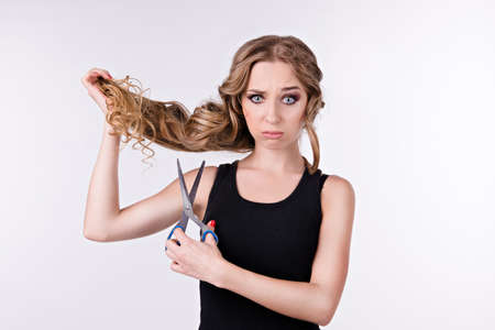 girl thinks cut her long hairの写真素材