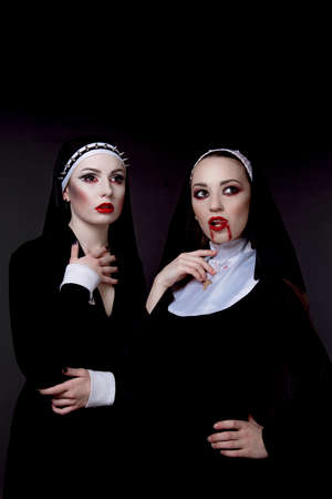 Halloween. The girls are dressed in sexy evil nunsの写真素材