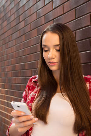 Girl in casual style with smartphoneの写真素材