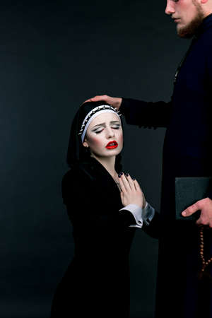 Halloween. A man and woman dressed as the clergyの写真素材