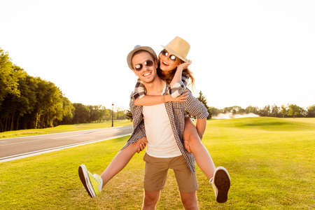 Happy young man piggybacking his girlfriend.の写真素材