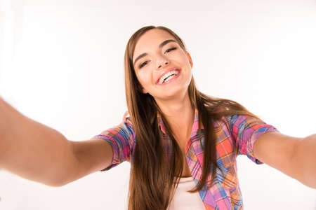young woman making selfie photo and smilingの写真素材