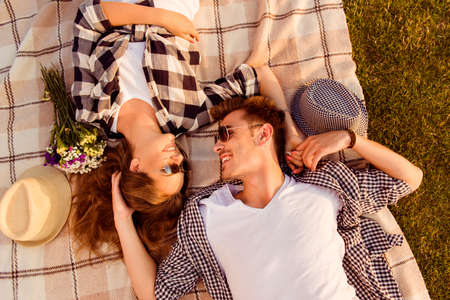 top view of a couple in love lying on a picnic plaidの写真素材