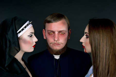 Halloween. A man and women dressed as the clergyの写真素材