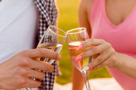 Cheers! Man and woman holding glasses