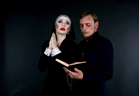 Halloween. A man and woman dressed as the clergyの写真素材