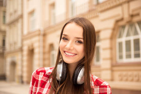 Cute girl listening to music on headphonesの写真素材
