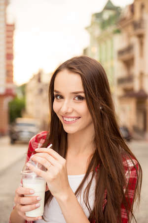 beautiful girl drinking a milkshakeの写真素材