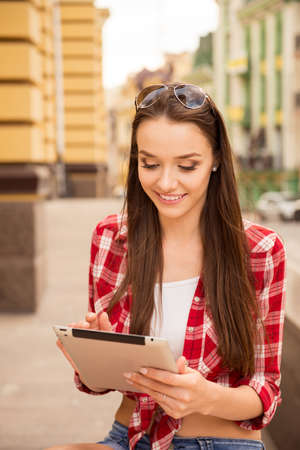pretty girl smiling with a tabletの写真素材