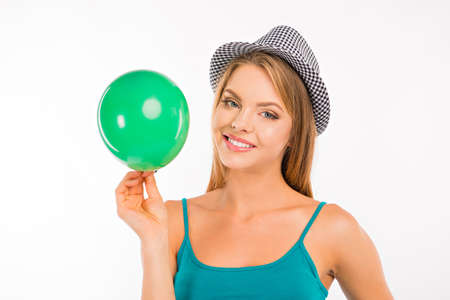 happy girl with green balloon smilingの写真素材