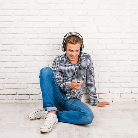 man with headphones sitting on the floorの写真素材