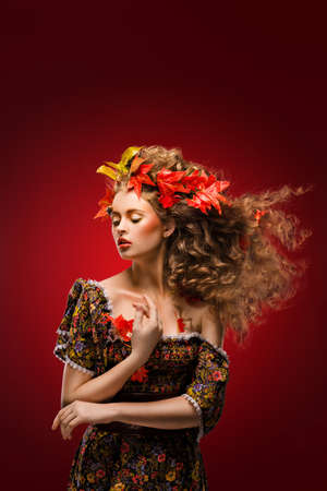 Autumn girl on a red backgroundの写真素材