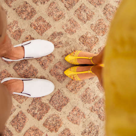 legs of loving couples on the pavementの写真素材