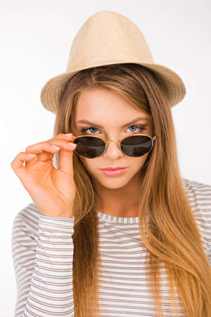 sexy girl with a hat put the glasses on her noseの写真素材