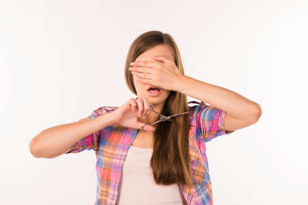 Woman cutting her hair. Problem of split endsの写真素材