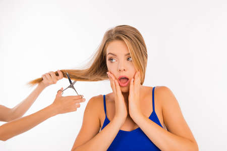 frightened woman going to cut her split endsの写真素材