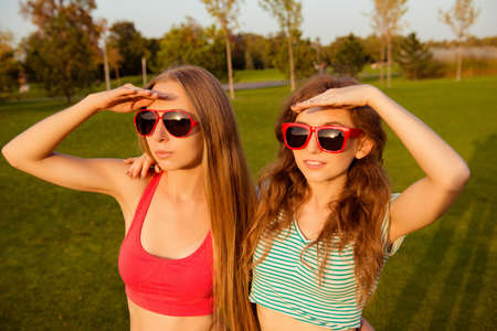 two sexy girls with red glassesの写真素材