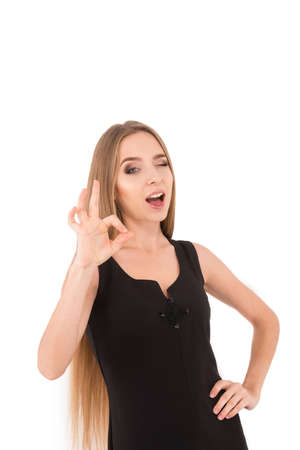 Happy smiling beautiful young business woman showing okay gesture, isolated over white backgroundの写真素材