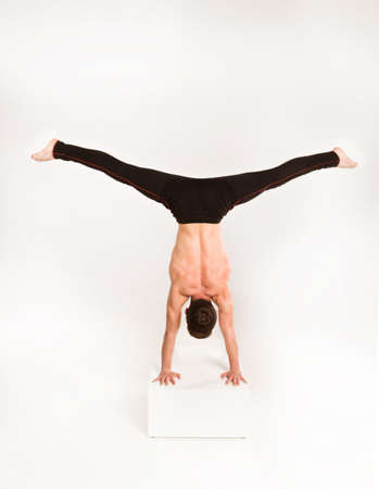man stretch gymnastic balance posture isolated studio on white background.