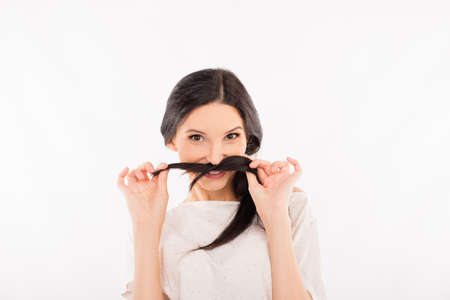 funny girl fooling around and holding her strand of hairの写真素材