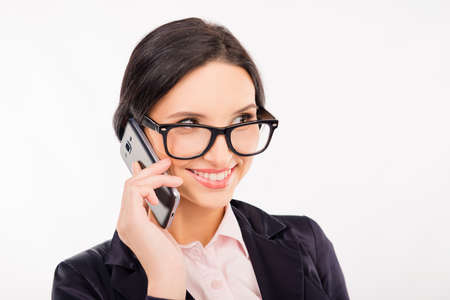 Beautiful businesswoman in glasses talking on the  phone and smiling