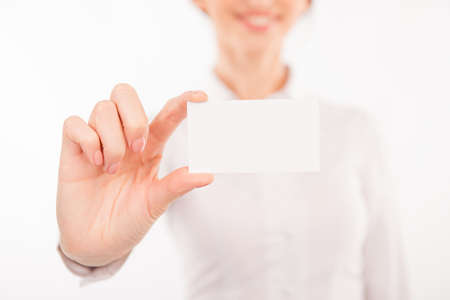 Woman with business card. Beautiful young woman in formalwear stretching out her business cardの写真素材