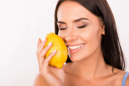 sexy beautiful young woman sniffing the scent of lemonの写真素材